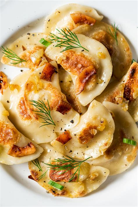 Pierogi kitchen - 1. Rinse potatoes, place in pot with enough water to cover. Bring to a boil and simmer for about 30 minutes or until fork tender. Drain. 2. Let potatoes cool enough until easy to handle. Peel and rice potatoes into large bowl. 3. Cook onions in the butter until soft, but not browned.